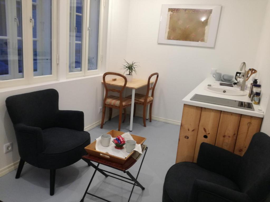 a kitchen with two chairs and a table and a sink at Matrix Garden Apartments in Tallinn