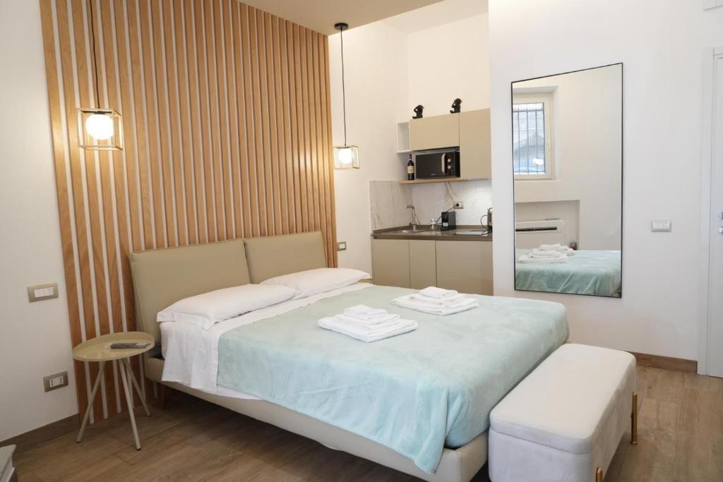 a small bedroom with a bed and a mirror at Around Castel Sant’Angelo in Rome