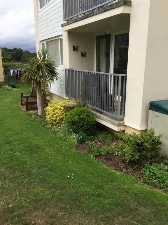a front porch of a house with a balcony at Dawlish Warren Apartments in Dawlish