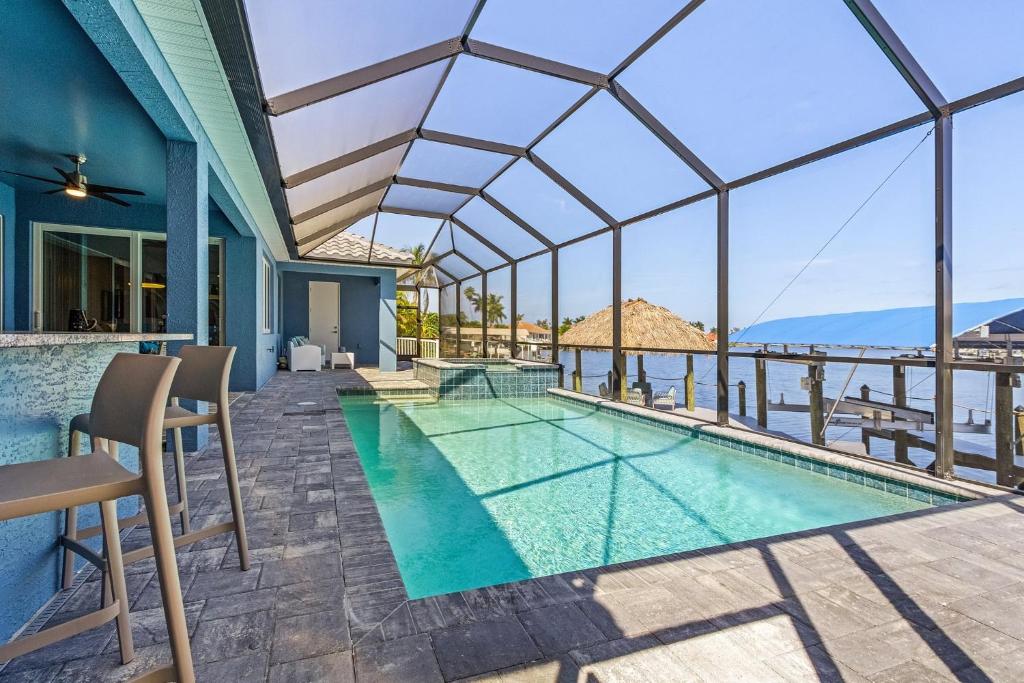 a swimming pool with a view of the ocean from a house at BIG WATER VIEW!, Heated Saltwater Pool and Spa - Villa Manatees Crossing - Roelens in Matlacha