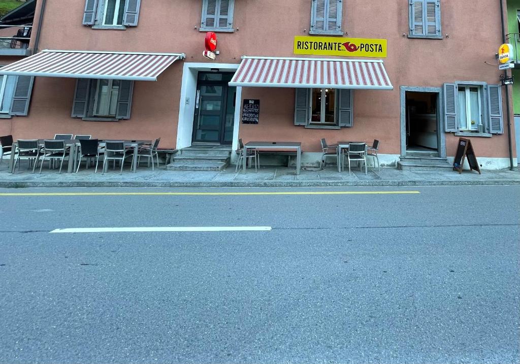 a restaurant with tables and chairs on the side of a building at HOTEL. RISTORANTE. DELLA POSTA CAMA in Cama