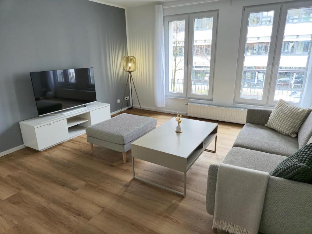 a living room with a couch and a tv at Aus alt wird neu - Apartment in Essener City in Essen