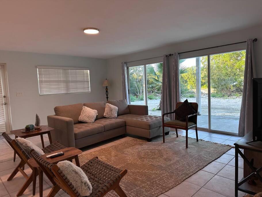 a living room with a couch and a table at Entire Waterfront House in Turtle Cove