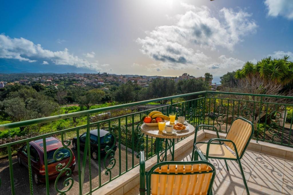 a balcony with a table and chairs with a view at Kallithea Studios & Apts in Lakíthra