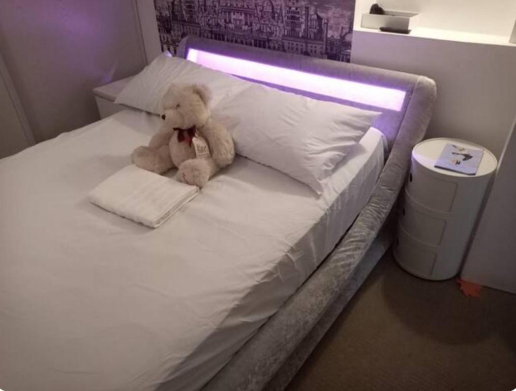 a teddy bear sitting on top of a bed at GORGEOUS FlatB Central London Liverpool St Station in London