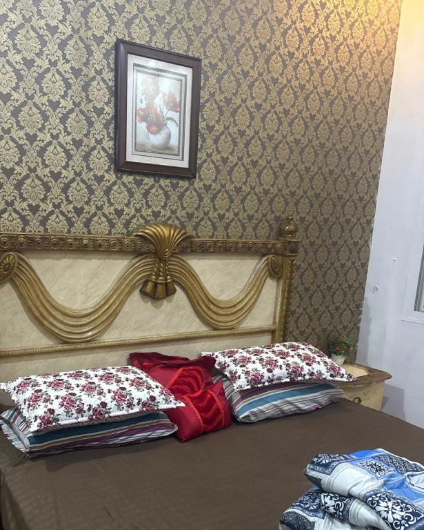 a bedroom with a bed with two pillows on it at غرفه وحمام مشترك داخل شقه مشتركه Single room and sharedللرجال فقط bathroom 1 Jeddah Corniche in Jeddah