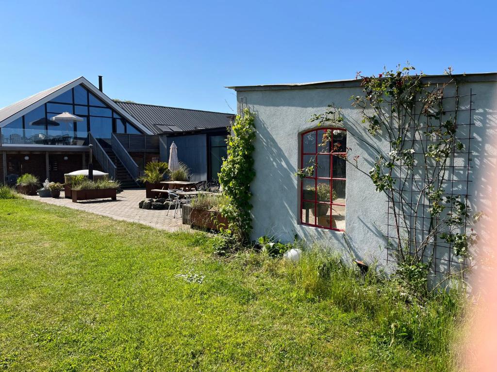 a house with a grass yard next to a building at Høloftet bb in Esbjerg