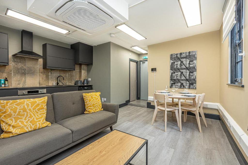 a living room with a couch and a table at Charming 1BR Flat in the Heart of City of London in London