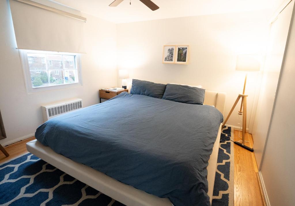 a bedroom with a bed with a blue comforter at Perfect For Families That Want To Be Close To Dc in Alexandria