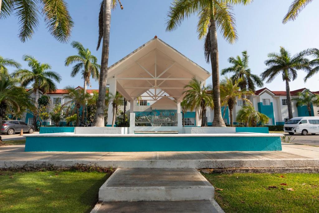 a building with palm trees in front of it at Hotel Ocean View in Campeche