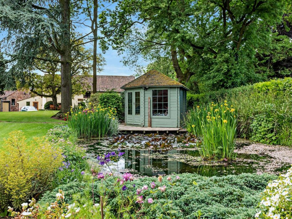 a small green house with a pond in a garden at 1 bed property in Taunton 58511 in Taunton