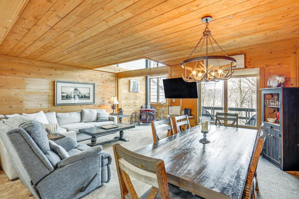 a living room with a wooden ceiling and a dining table at Pristine Resort Townhome 2 Mi to Seven Springs Mtn in Champion