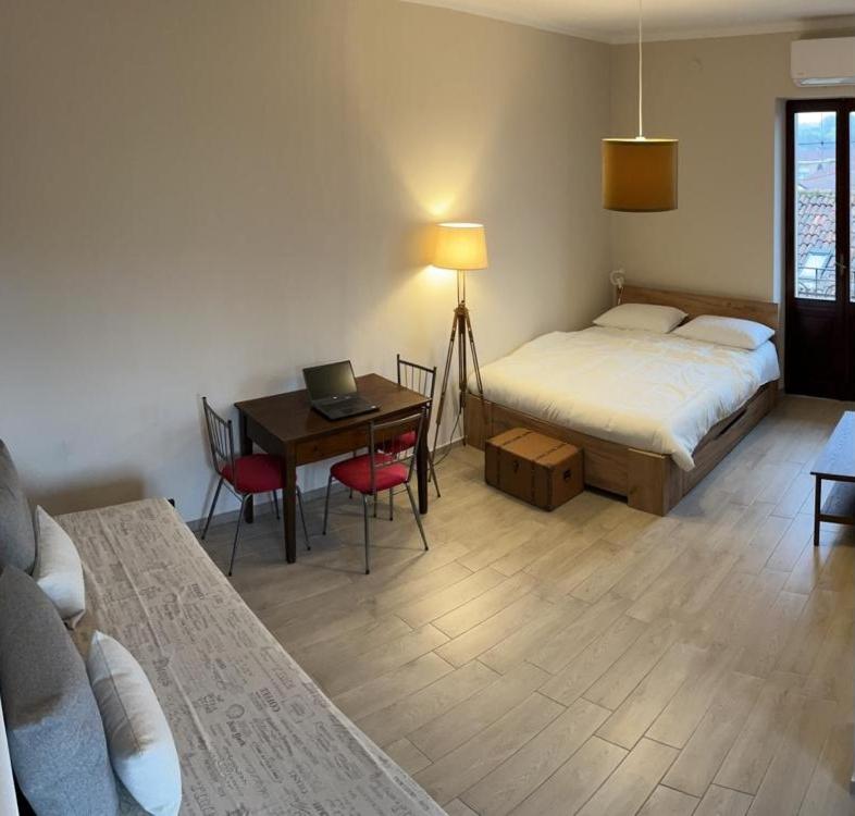 a bedroom with a bed and a desk with a laptop at Nel centro storico di Moncalieri in Moncalieri