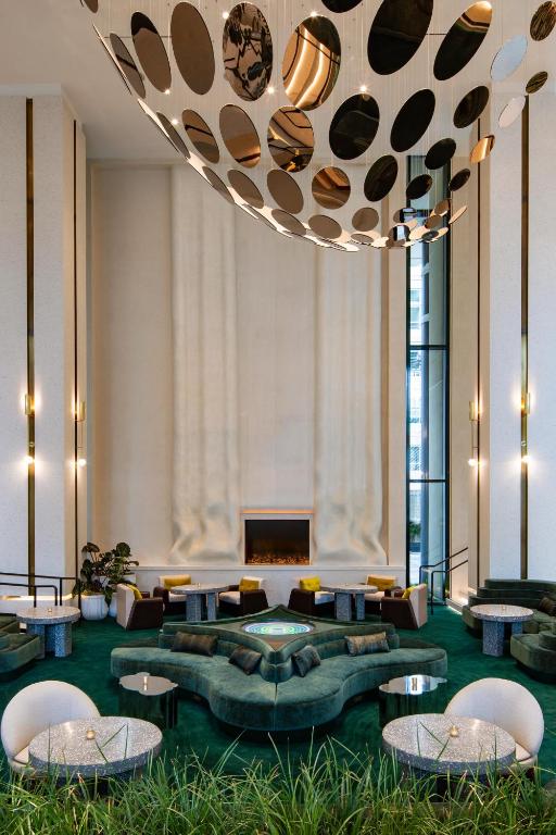 a lobby with couches and tables and a large chandelier at W Hollywood in Los Angeles