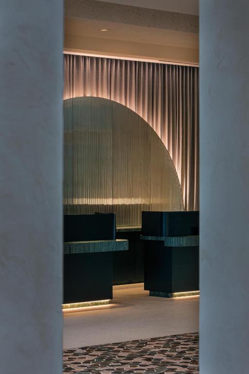 a lobby with a row of desks and a curtain at W Hollywood in Los Angeles
