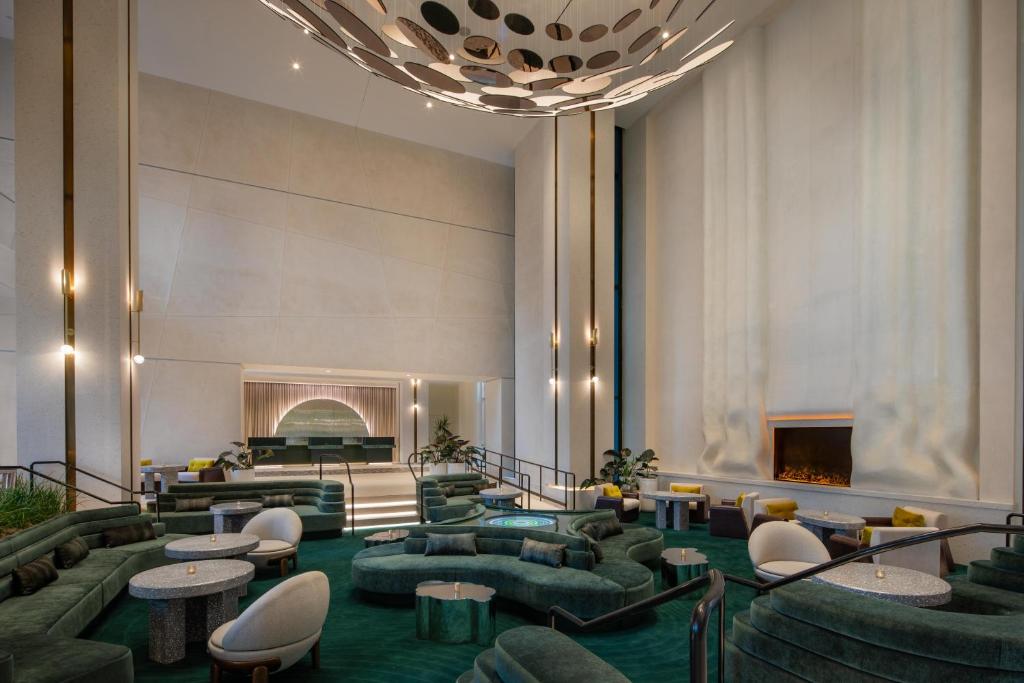 a lobby with couches and tables and a fireplace at W Hollywood in Los Angeles