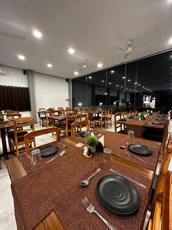 a dining room with a table with plates on it at Golden Pearl Resort By Gemstone Hospitality in Alibag