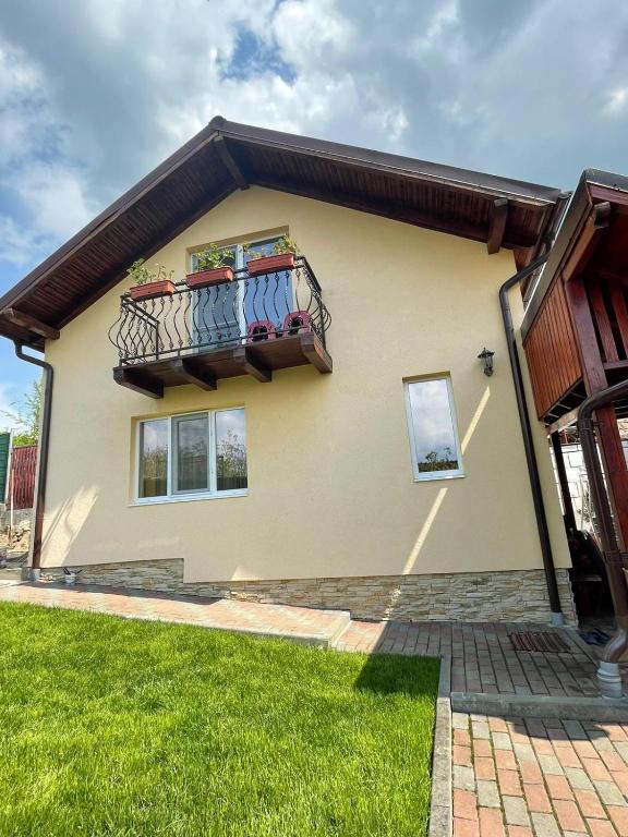 a house with a balcony with towels on it at Casa Matei in Turda