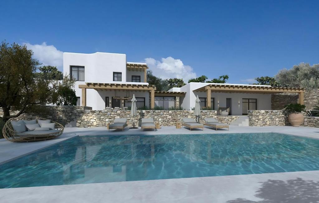 a villa with a swimming pool in front of a house at Amazing Villa 6bed in Agios Lazaros Mykonos in Psarou