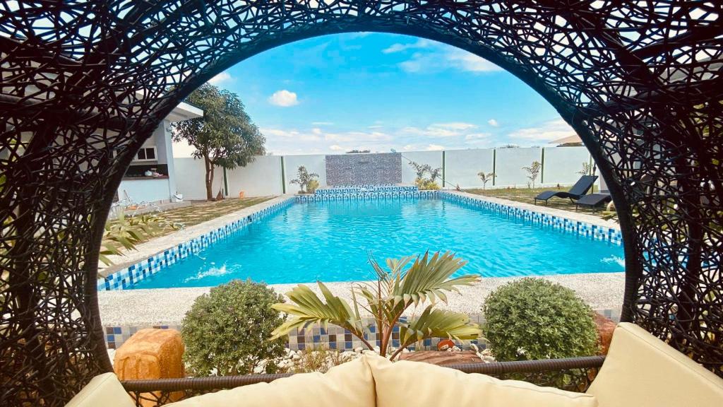 a view of a swimming pool from an archway at Steffen Resort in Dinalupihan