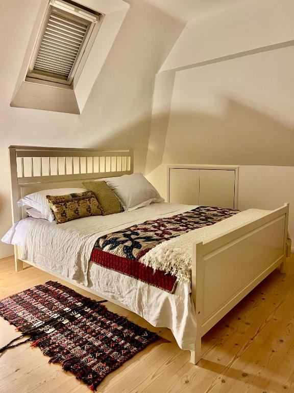 a bedroom with a large bed with a rug at Pluto House in Kent