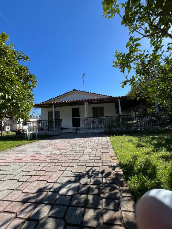 a house with a brick driveway in front of it at Lina's Residence in Stavros