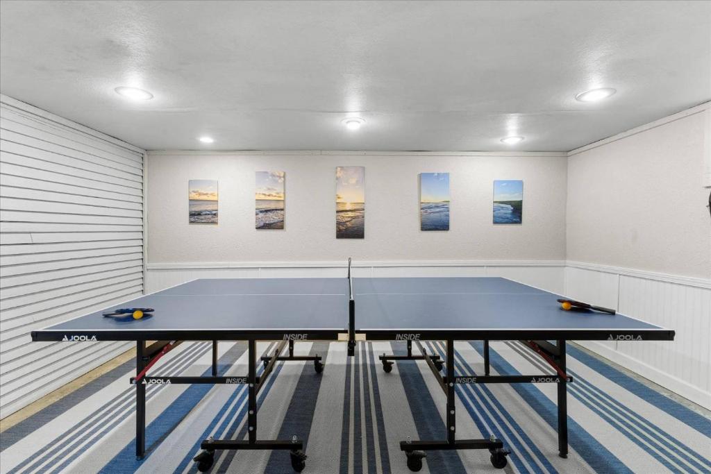 a ping pong table in a room with paintings at C Street Charm in Coeur d'Alene