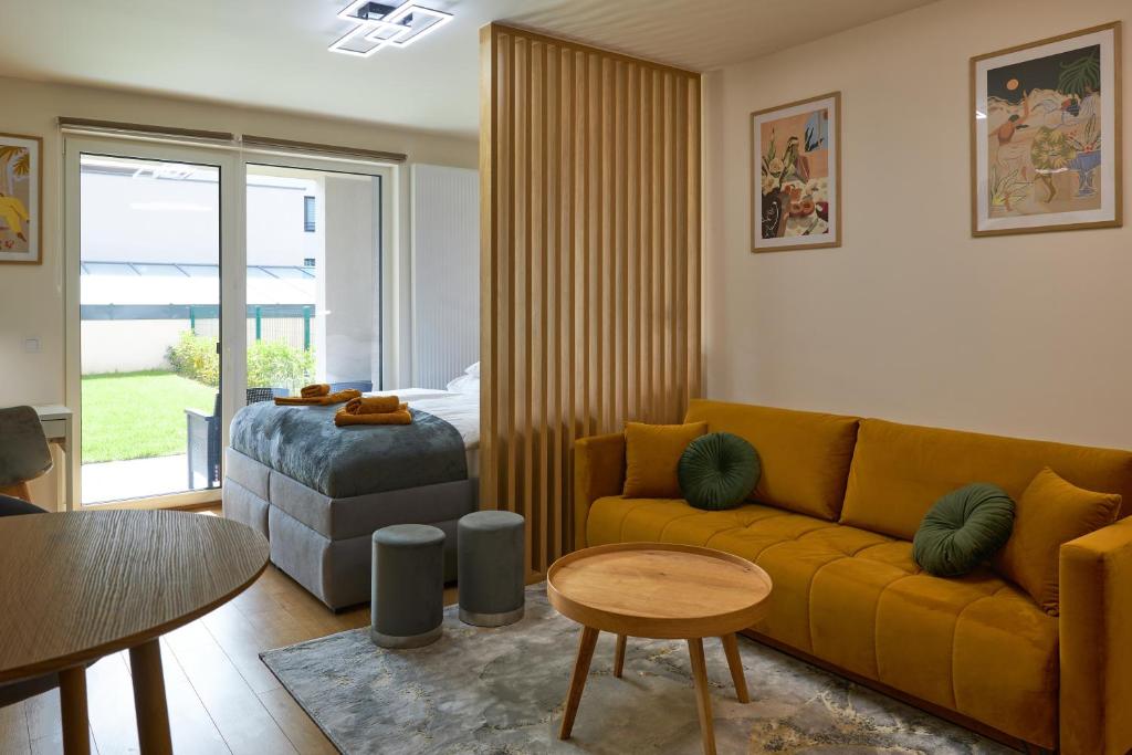a living room with a couch and a bed at Alfa Albelli Free Parking Air Condition in Košice