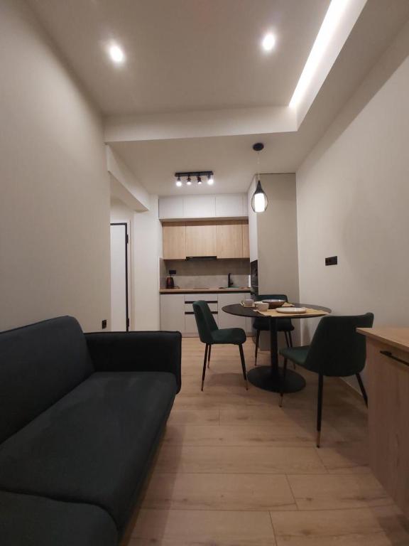 a living room with a couch and a table at Real City Karagiorgi in Athens