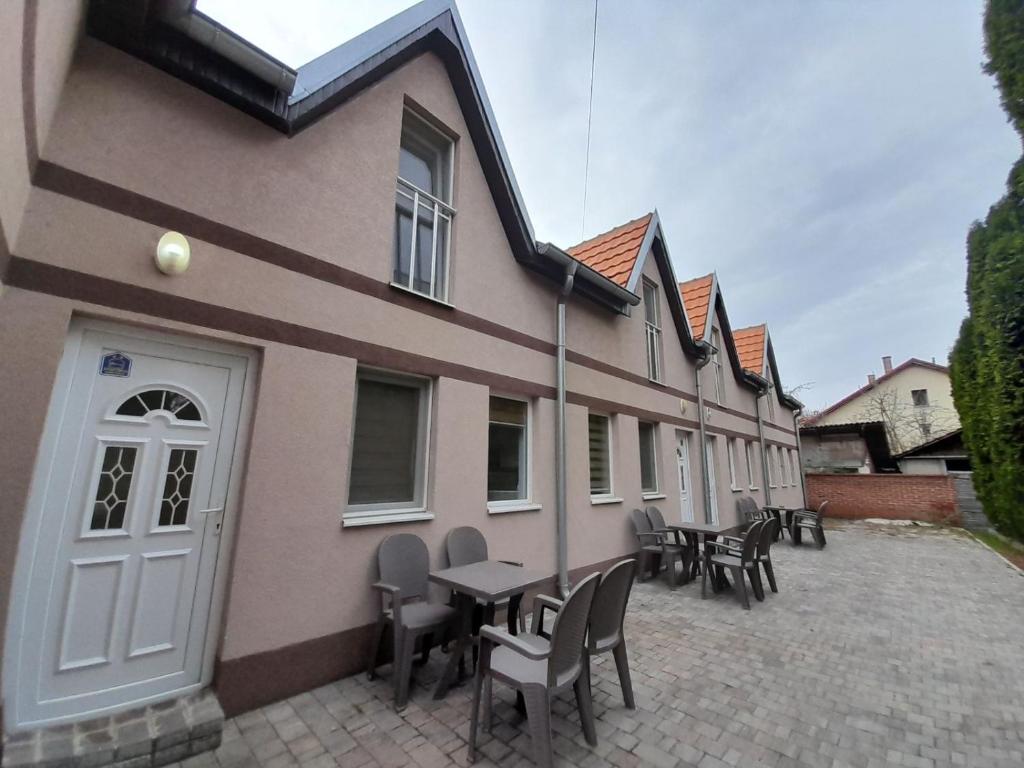 a building with chairs and tables in front of it at Stevan Sremac in Soko Banja