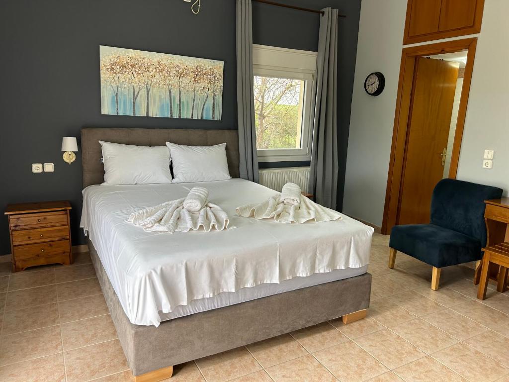 a bedroom with a bed with towels on it at Akrotiri studios in Samothraki