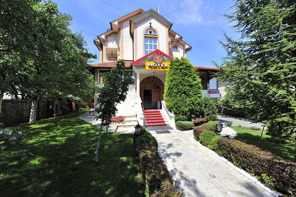 a house with a sign on the front of it at Hotel Sucevic Garni in Belgrade