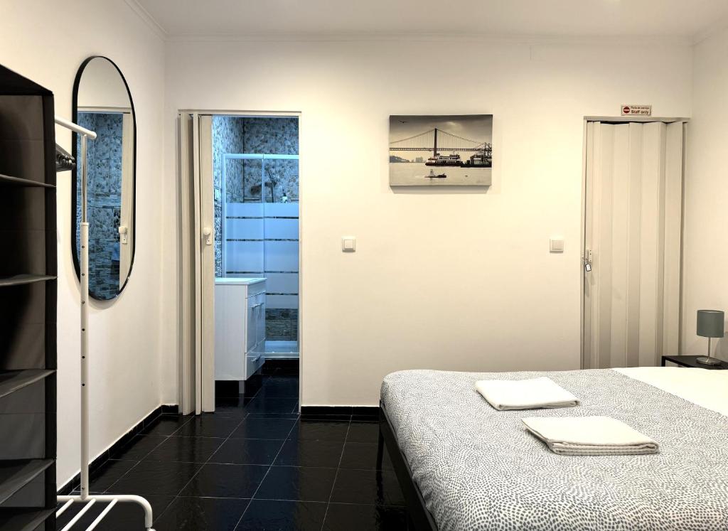 a bedroom with a bed and a bathroom at Casa do Pereira in Lisbon