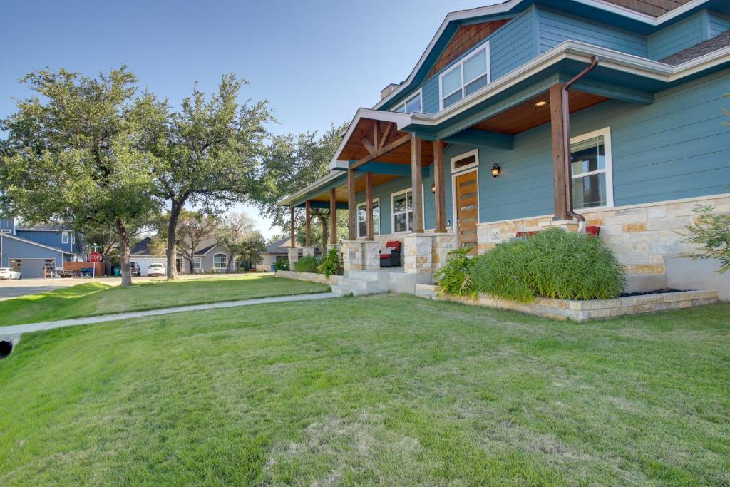 una casa azul con césped delante en Modern Lago Vista Home with Pool and Lake Access!, en Lago Vista