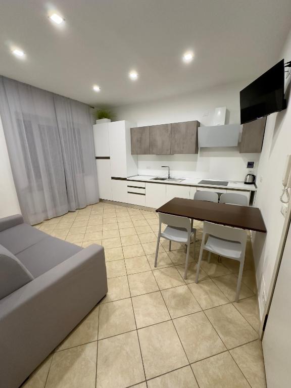 a kitchen with a table and chairs in a room at Appartamento La Mola in Varazze