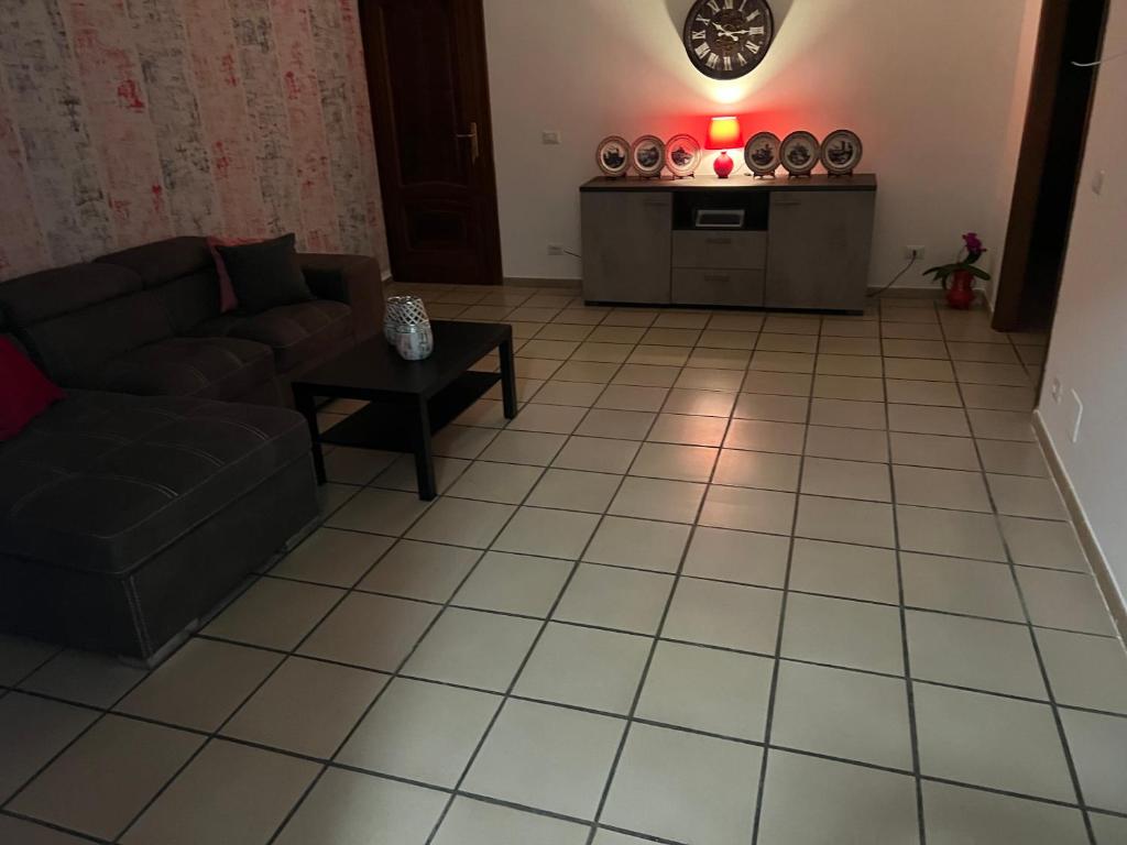 a living room with a couch and a table at Casa vacanza Nada in Dogliani