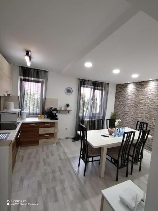 a kitchen and dining room with a table and chairs at Apartament in centrul istoric in Baia Mare