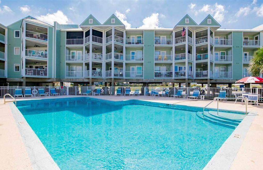 a pool in front of a large apartment building at Jubilee Landing 107 in Orange Beach
