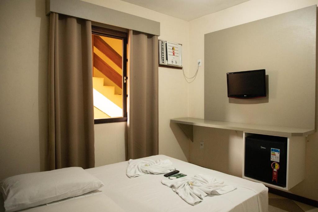 Postel nebo postele na pokoji v ubytování Lonier Praia Inn Flats