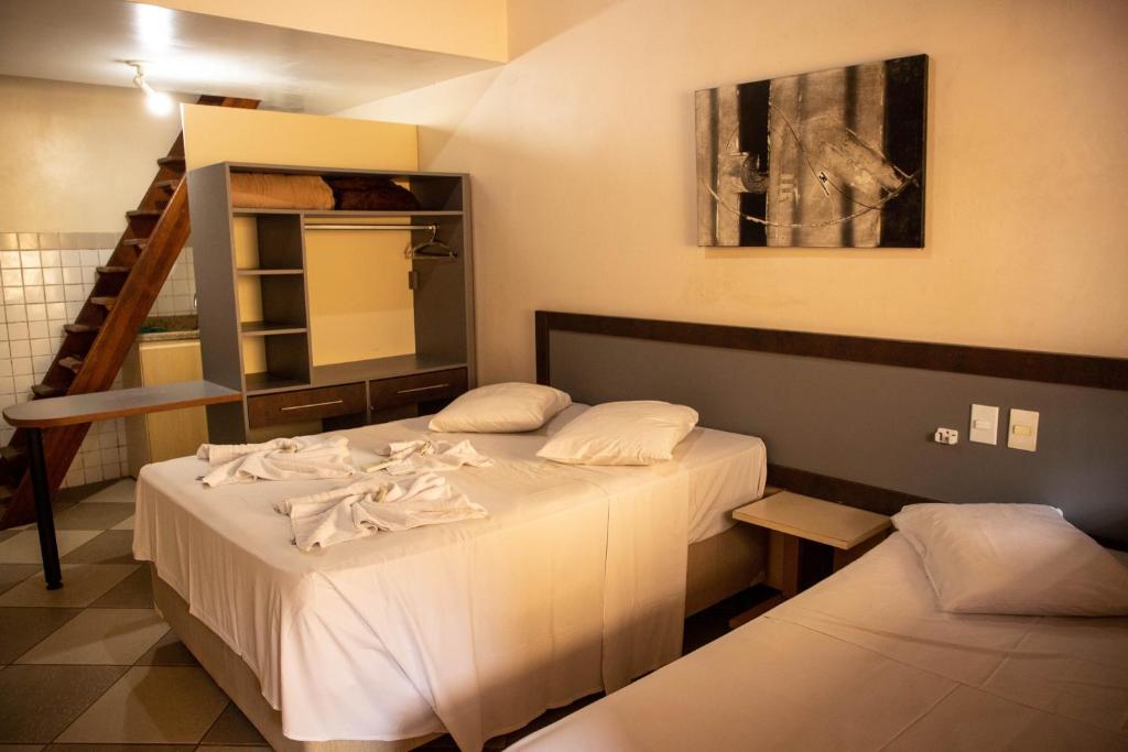 Postel nebo postele na pokoji v ubytování Lonier Praia Inn Flats