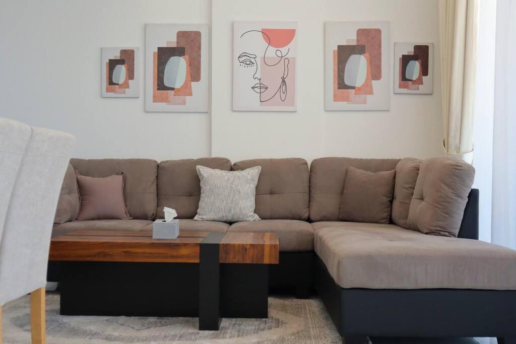 a living room with a couch and a coffee table at Wanderlust 2BR Apartment in Abu Dhabi