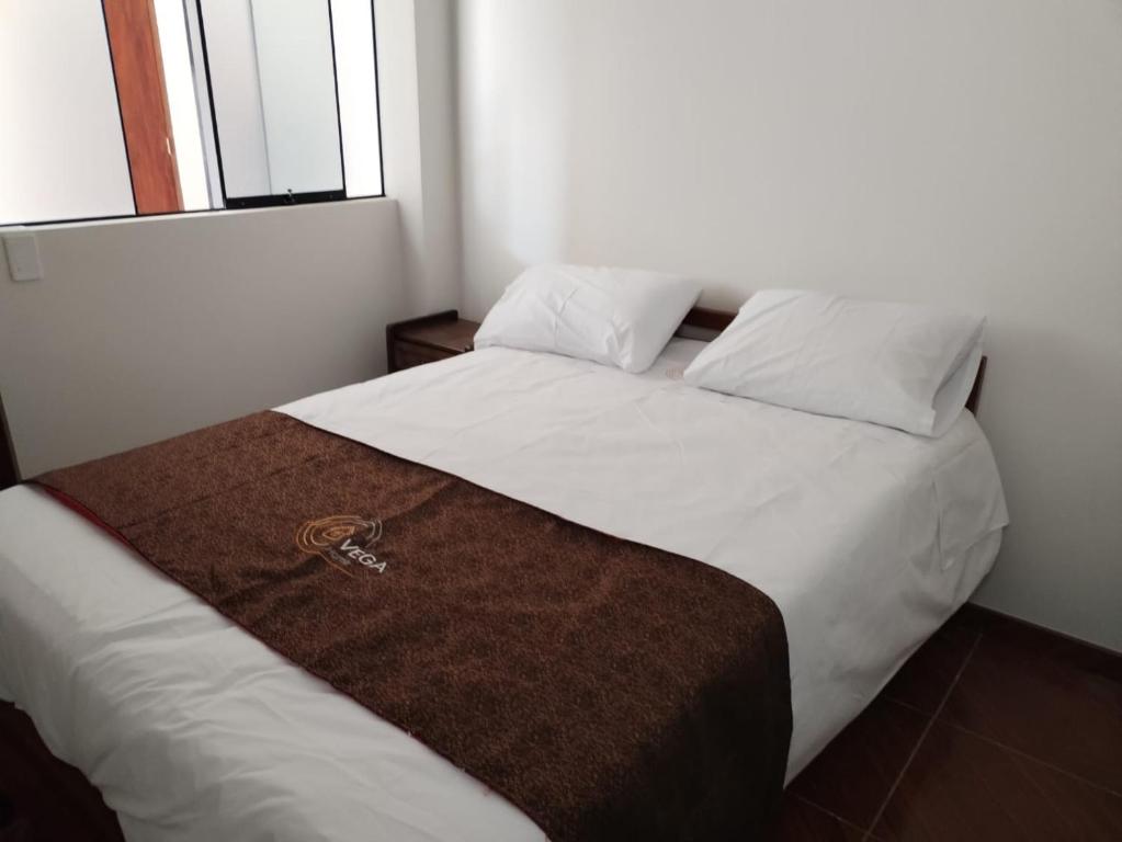 Un pat sau paturi într-o cameră la VEGA HOME