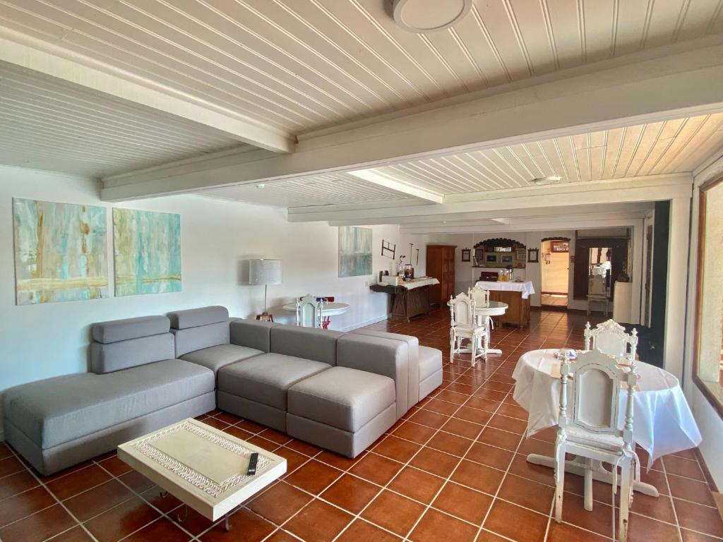a living room with a couch and a table at Vinha da Quinta in Sintra