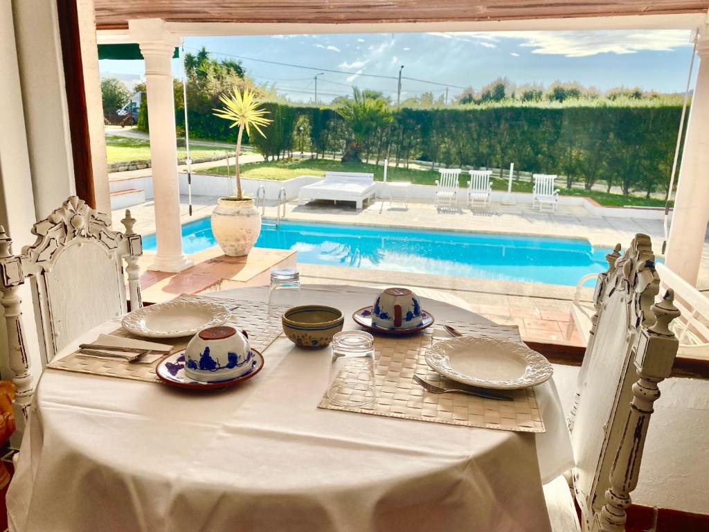 a white table with plates and bowls on top at Vinha da Quinta in Sintra