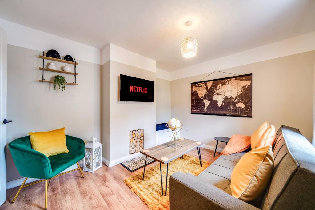 a living room with a couch and a table at Stylish Victorian house, close to City Centre in Colchester