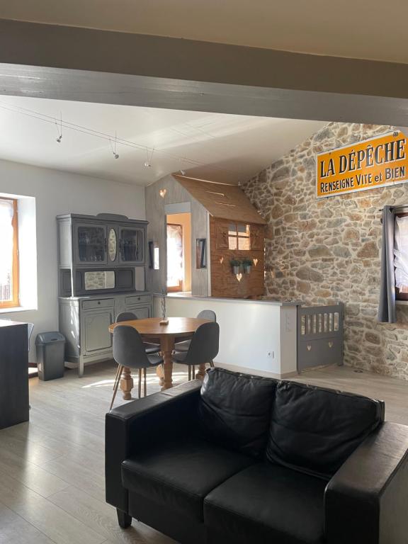 een woonkamer met een bank en een tafel bij Chez Tony et Laurie in Montbrun-des-Corbières