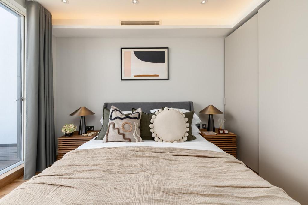 a bedroom with a large bed with pillows at £2 Million Covent Garden Lux Apartment in London