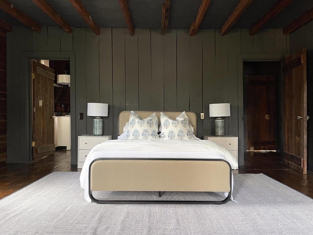 a bedroom with a large bed with two night stands at Meadows Mill House III in Salem