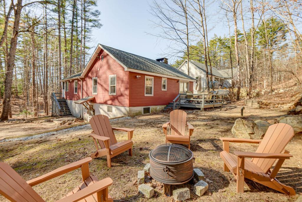 a yard with chairs and a fire pit in front of a house at Inviting Alton Bay Home Near Lake Winnipesaukee! in Alton Bay