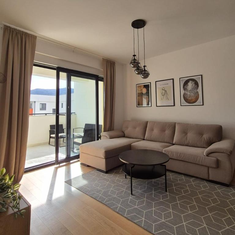 a living room with a couch and a table at Apartman Nocturno Trebinje in Trebinje